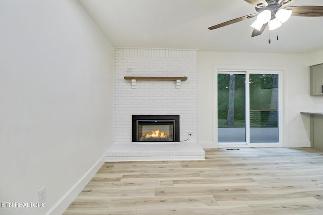 1122 N Shady Lane Loop, Clarkrange, TN 38553 - unfurnished living room featuring light wood finished floors, a fireplace, and baseboards