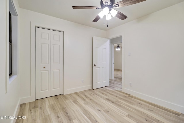 1122 N Shady Lane Loop, Clarkrange, TN 38553 - unfurnished bedroom with light wood-style flooring, a closet, baseboards, and a ceiling fan