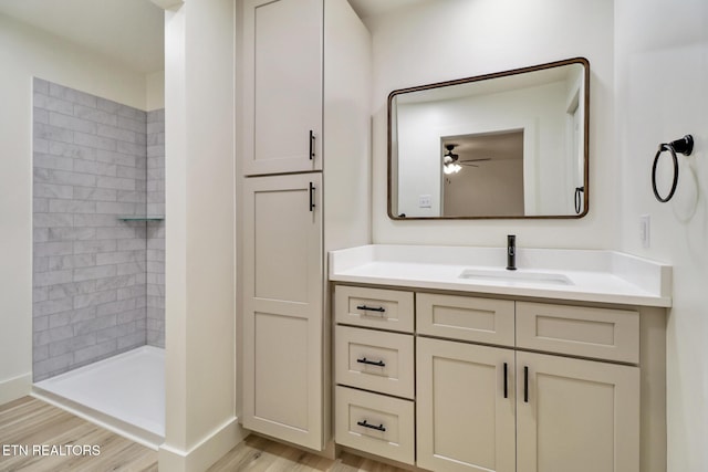 1122 N Shady Lane Loop, Clarkrange, TN 38553 - bathroom featuring vanity, wood finished floors, a tile shower, a ceiling fan, and baseboards