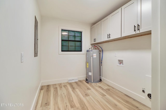 1122 N Shady Lane Loop, Clarkrange, TN 38553 - laundry area with electric water heater, cabinet space, light wood-style flooring, washer hookup, and baseboards