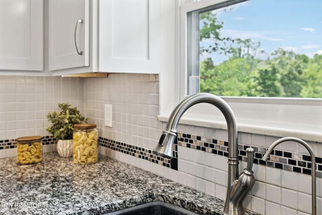 7613 Scenic View Dr, Knoxville, TN 37938 - kitchen view of white cabinets, tasteful backsplash, a sink, and dark stone counters