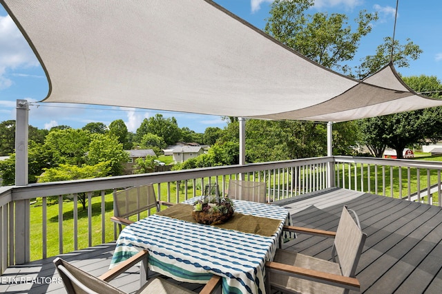 7613 Scenic View Dr, Knoxville, TN 37938 - wooden deck featuring a lawn, outdoor dining space, and view of wooded area
