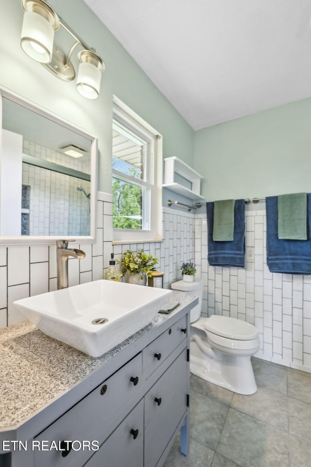 7613 Scenic View Dr, Knoxville, TN 37938 - bathroom with tile walls, toilet, vanity, tile patterned floors, and a shower