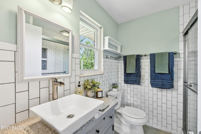 7613 Scenic View Dr, Knoxville, TN 37938 - full bathroom with tile walls, toilet, a tile shower, vanity, and a wainscoted wall
