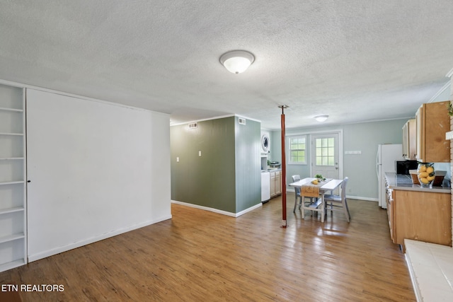 7613 Scenic View Dr, Knoxville, TN 37938 - kitchen featuring light wood-style floors, a textured ceiling, light countertops, freestanding refrigerator, and baseboards
