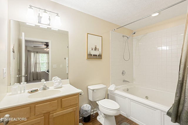 2032 Slippery Rock Cir, Pigeon Forge, TN 37862 - bathroom featuring shower / bath combo with shower curtain, toilet, vanity, wood finished floors, and a textured ceiling