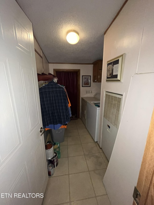 130 New Light Cir, Winfield, TN 37892 - washroom featuring washing machine and dryer, a textured ceiling, cabinet space, light tile patterned floors, and a heating unit