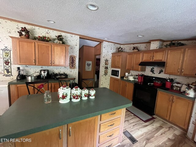 130 New Light Cir, Winfield, TN 37892 - kitchen featuring black electric range oven, crown molding, built in microwave, under cabinet range hood, and wallpapered walls
