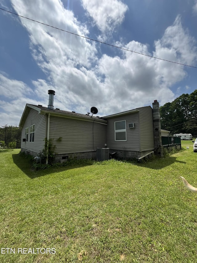 130 New Light Cir, Winfield, TN 37892 - back of property with a lawn, cooling unit, and a chimney