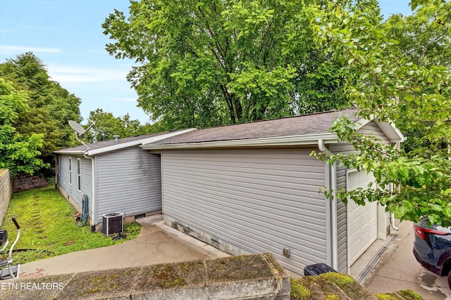 501 Park Ave, Clinton, TN 37716 - view of side of home featuring crawl space, central AC unit, roof with shingles, a garage, and an outbuilding