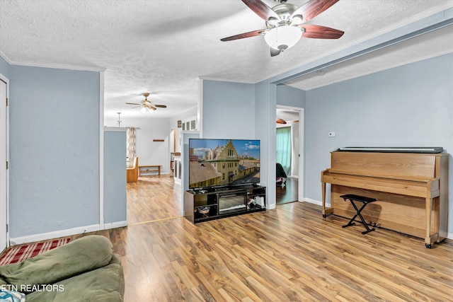 501 Park Ave, Clinton, TN 37716 - living area with a ceiling fan, wood finished floors, a textured ceiling, baseboards, and crown molding
