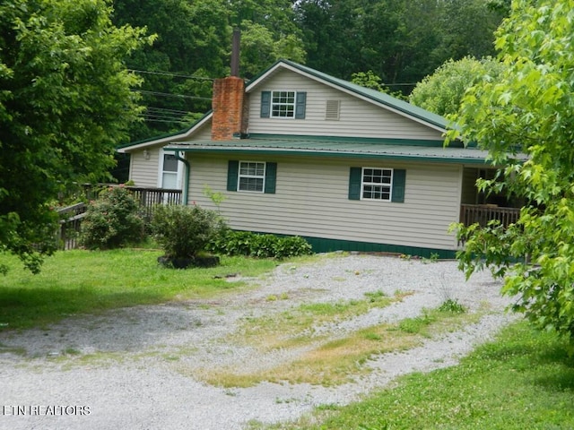 232 Sallings Rd, Luttrell, TN 37779 - view of home's exterior with a chimney, metal roof, and driveway