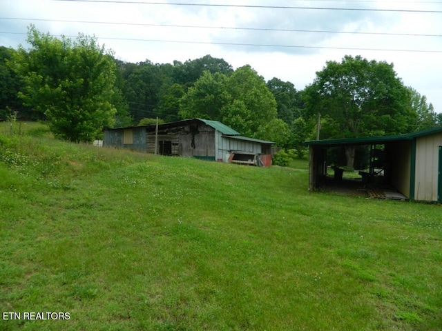232 Sallings Rd, Luttrell, TN 37779 - view of grassy yard with an outbuilding, an outdoor structure, and a carport