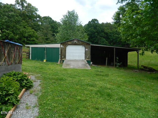 232 Sallings Rd, Luttrell, TN 37779 - view of green lawn featuring a detached garage and an outbuilding