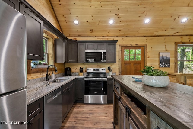 1705 Pkwy View Ct, Sevierville, TN 37876 - kitchen featuring appliances with stainless steel finishes, a sink, wood ceiling, recessed lighting, and light stone counters