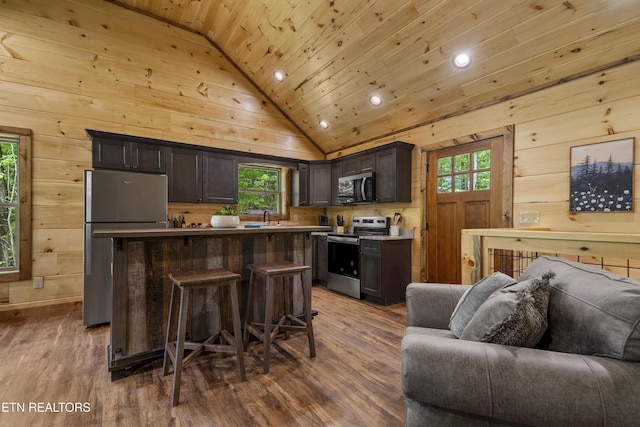 1705 Pkwy View Ct, Sevierville, TN 37876 - kitchen featuring appliances with stainless steel finishes, open floor plan, vaulted ceiling, wooden ceiling, and a kitchen breakfast bar