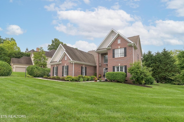 817 Vista Oaks Ln, Knoxville, TN 37919 - view of front facade featuring brick siding, a front lawn, and a chimney