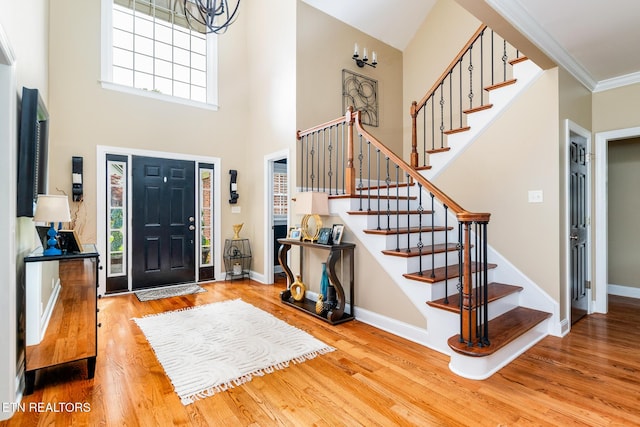 817 Vista Oaks Ln, Knoxville, TN 37919 - entrance foyer featuring wood finished floors, stairs, healthy amount of natural light, a high ceiling, and ornamental molding