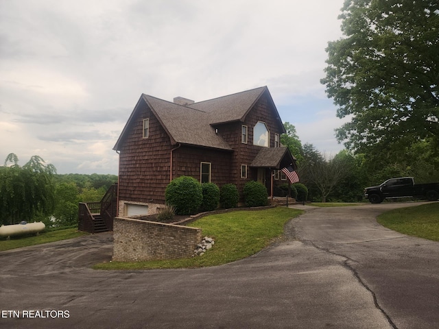 219 Fooshee, Ten Mile, TN 37880 - view of property exterior with driveway, roof with shingles, an attached garage, a yard, and a chimney