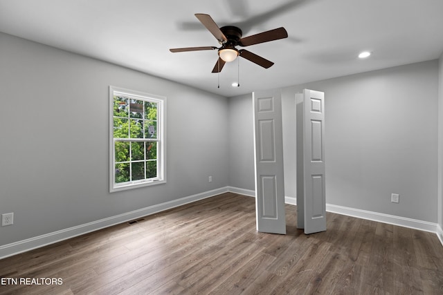 136 Dudley Ln, Tazewell, TN 37879 - unfurnished bedroom with baseboards, dark wood-type flooring, recessed lighting, and ceiling fan