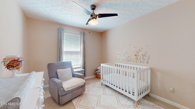 1859 Poplar Hill Rd, Knoxville, TN 37922 - carpeted bedroom featuring baseboards, a crib, a textured ceiling, and ceiling fan
