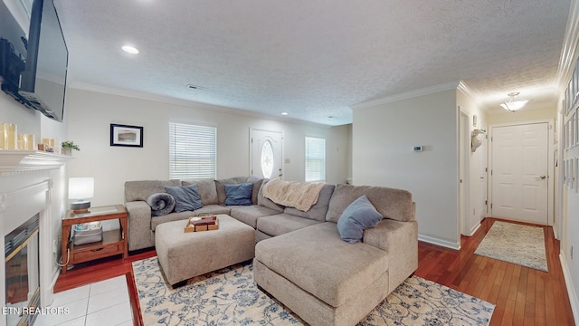 1859 Poplar Hill Rd, Knoxville, TN 37922 - living room with ornamental molding, a glass covered fireplace, recessed lighting, light wood-style flooring, and a textured ceiling