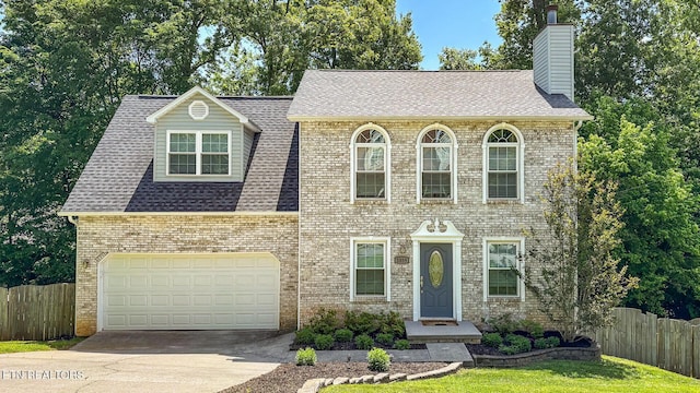 1859 Poplar Hill Rd, Knoxville, TN 37922 - view of front of home featuring concrete driveway, a chimney, an attached garage, and brick siding