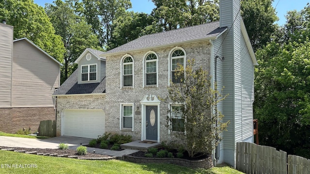 1859 Poplar Hill Rd, Knoxville, TN 37922 - colonial-style house featuring driveway, a garage, brick siding, and roof with shingles
