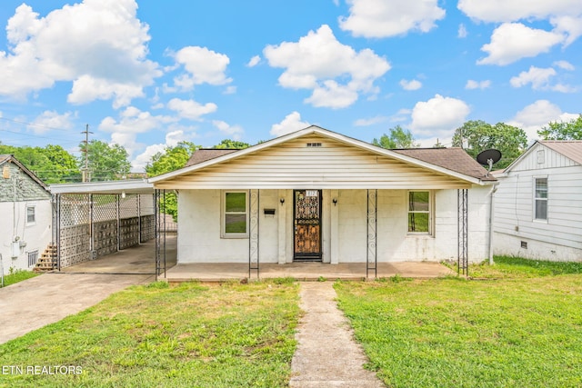 812 W Emerald Ave, Knoxville, TN 37921 - bungalow-style home featuring concrete driveway, a front lawn, covered porch, a shingled roof, and concrete block siding