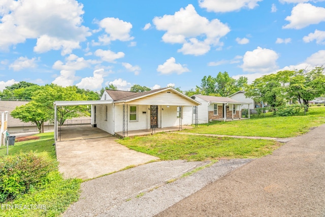 812 W Emerald Ave, Knoxville, TN 37921 - ranch-style home featuring driveway, covered porch, a front yard, and a carport