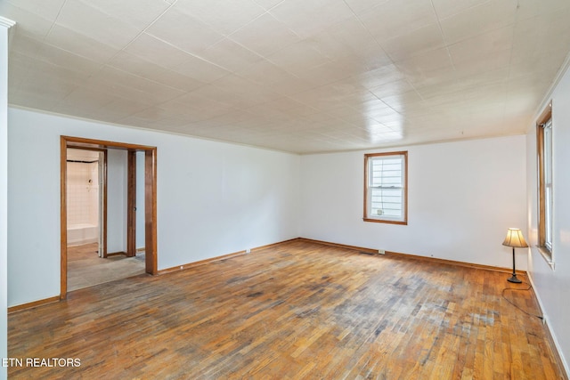 812 W Emerald Ave, Knoxville, TN 37921 - spare room featuring wood-type flooring and baseboards