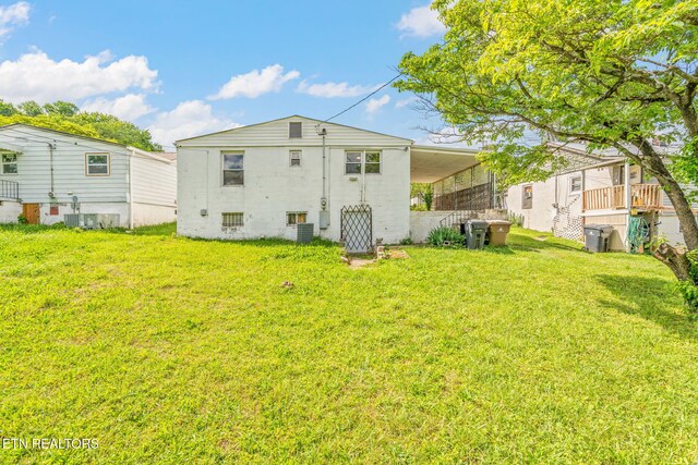 812 W Emerald Ave, Knoxville, TN 37921 - rear view of house featuring a yard, central air condition unit, and an attached carport