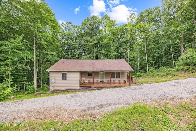 1103 Boles Beaty Rd, Alpine, TN 38543 - view of front of house featuring a porch, a view of trees, and a shingled roof