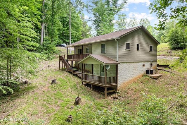 1103 Boles Beaty Rd, Alpine, TN 38543 - back of property featuring a deck, central air condition unit, and a shingled roof