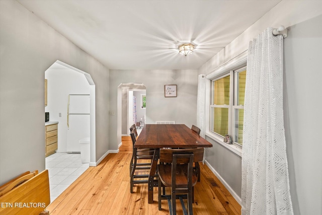 1103 Boles Beaty Rd, Alpine, TN 38543 - dining room featuring arched walkways, light wood-style floors, and baseboards
