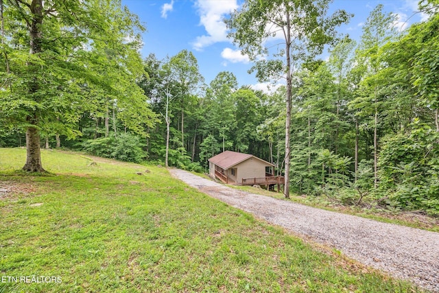 1103 Boles Beaty Rd, Alpine, TN 38543 - view of grassy yard featuring a forest view, gravel driveway, and a deck