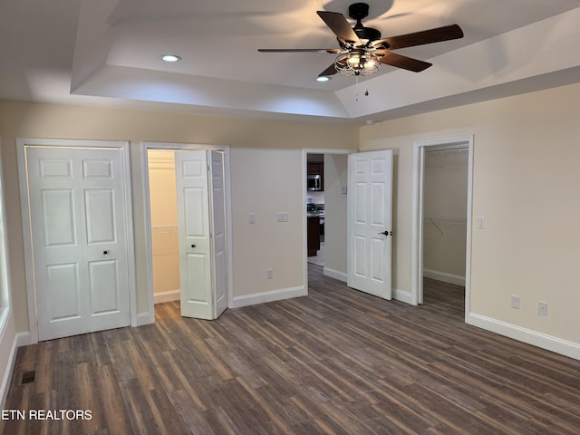 1847 Chinkapin Trl, Monterey, TN 38574 - unfurnished bedroom with a tray ceiling, a walk in closet, dark wood-style floors, baseboards, and recessed lighting