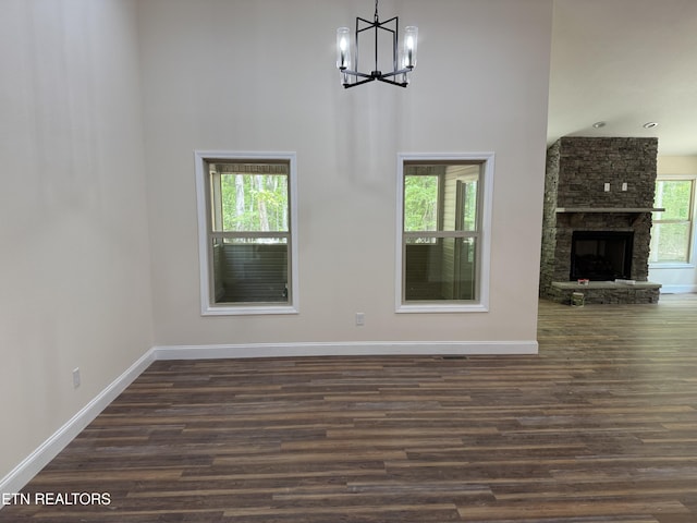 1847 Chinkapin Trl, Monterey, TN 38574 - unfurnished living room with a chandelier, baseboards, dark wood finished floors, and a high ceiling