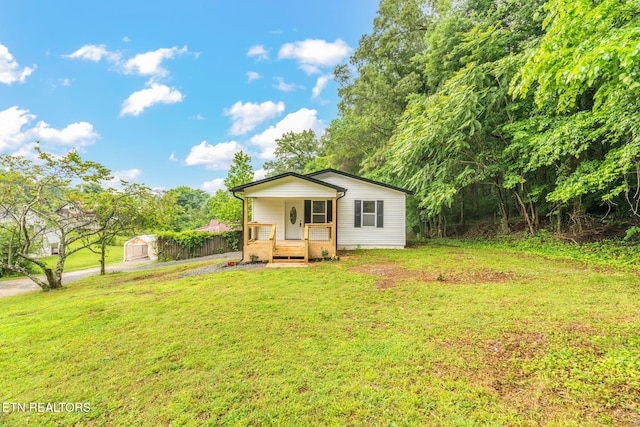 600 N Trinity Ave, Rockwood, TN 37854 - back of house with a porch and a lawn