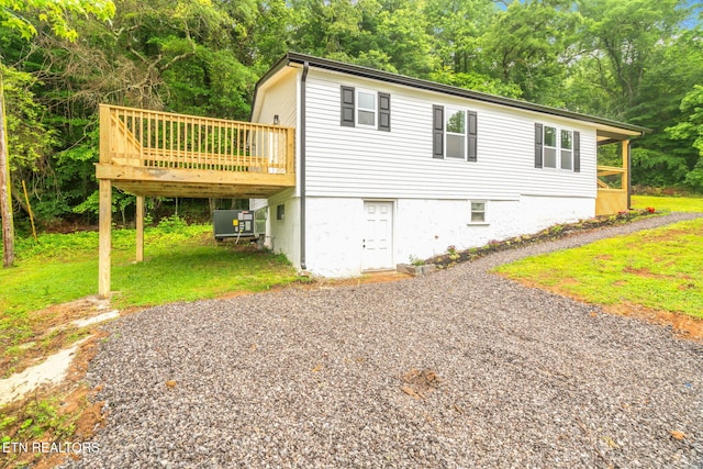 600 N Trinity Ave, Rockwood, TN 37854 - view of property exterior featuring a lawn, a wooden deck, and gravel driveway