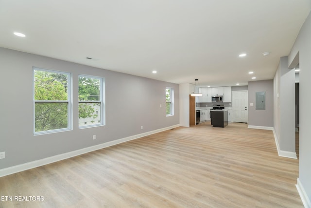600 N Trinity Ave, Rockwood, TN 37854 - unfurnished living room with electric panel, recessed lighting, healthy amount of natural light, baseboards, and light wood finished floors