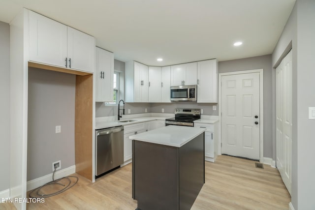 600 N Trinity Ave, Rockwood, TN 37854 - kitchen with appliances with stainless steel finishes, a sink, white cabinetry, light countertops, and baseboards