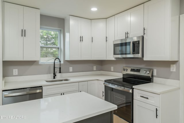 600 N Trinity Ave, Rockwood, TN 37854 - kitchen featuring appliances with stainless steel finishes, a sink, white cabinets, light countertops, and recessed lighting
