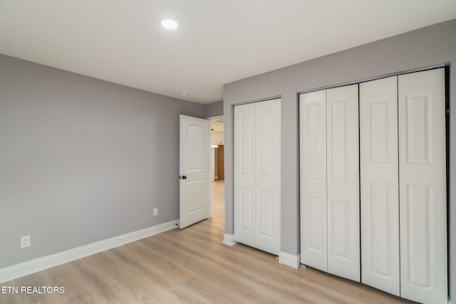 600 N Trinity Ave, Rockwood, TN 37854 - unfurnished bedroom featuring multiple closets, light wood-type flooring, baseboards, and recessed lighting