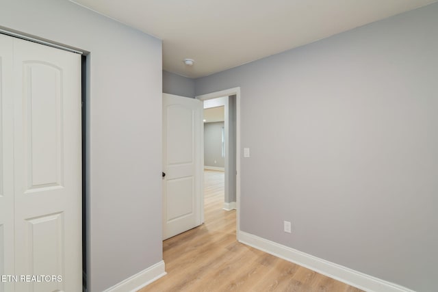 600 N Trinity Ave, Rockwood, TN 37854 - unfurnished bedroom with baseboards, light wood-style floors, and a closet