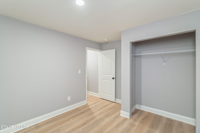 600 N Trinity Ave, Rockwood, TN 37854 - unfurnished bedroom with light wood-style flooring, baseboards, and a closet