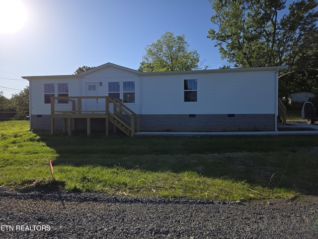 7922 Harmon Rd, Powell, TN 37849 - back of property with crawl space, a lawn, a wooden deck, and stairs