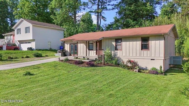 233 Doe Run Blvd, Clinton, TN 37716 - view of front of property featuring board and batten siding, central air condition unit, a front lawn, and a garage