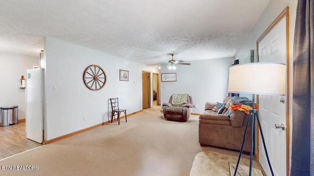 233 Doe Run Blvd, Clinton, TN 37716 - carpeted living room with ceiling fan, baseboards, and a textured ceiling