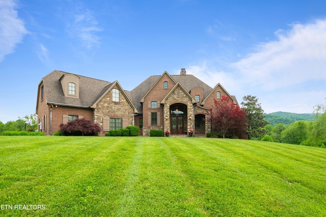759 Indian Mountain Rd, Jellico, TN 37762 - french country inspired facade featuring stone siding, a front lawn, and a chimney